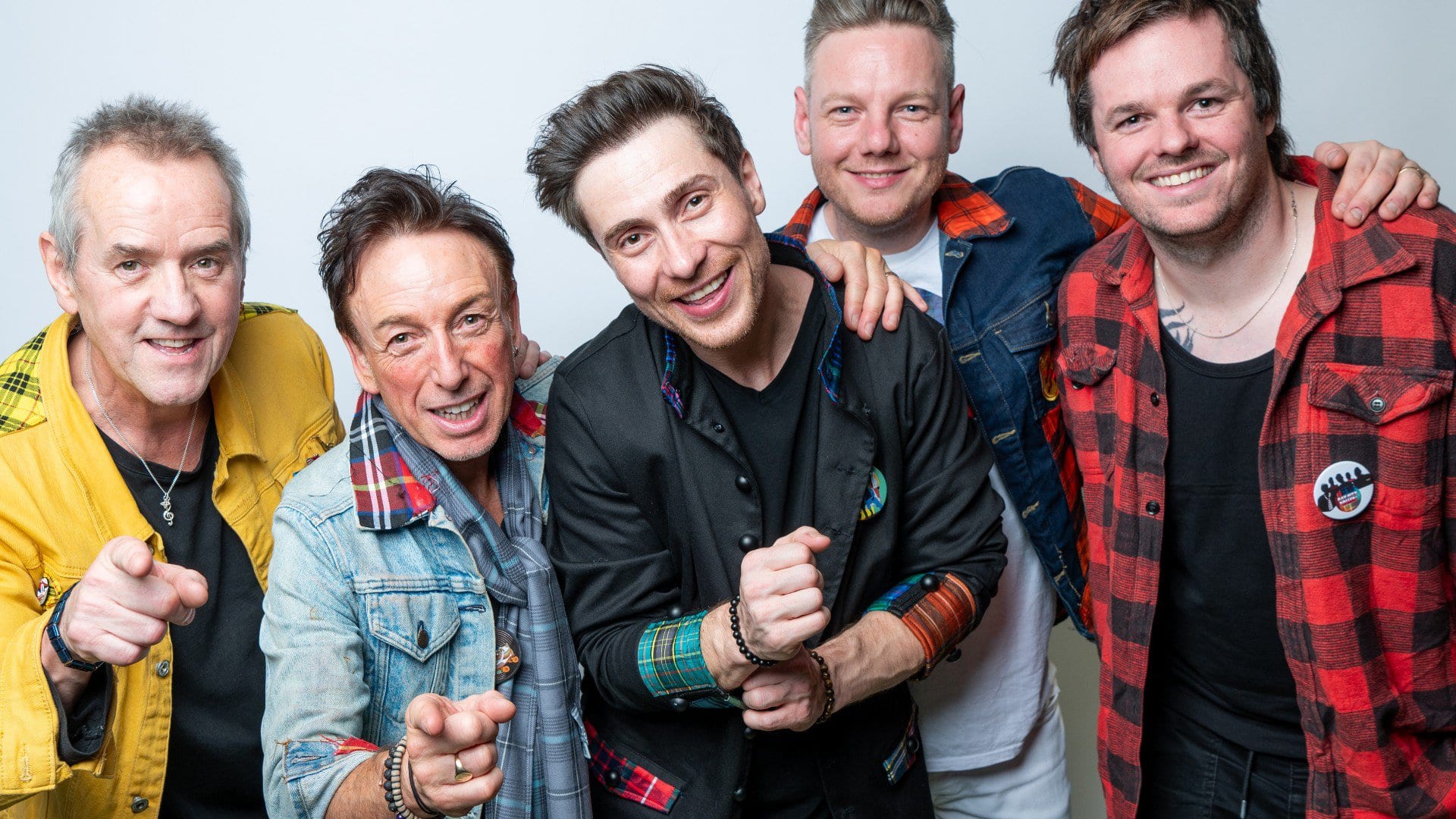 Live music performance at Replay Festival with vibrant band in colourful outfits.